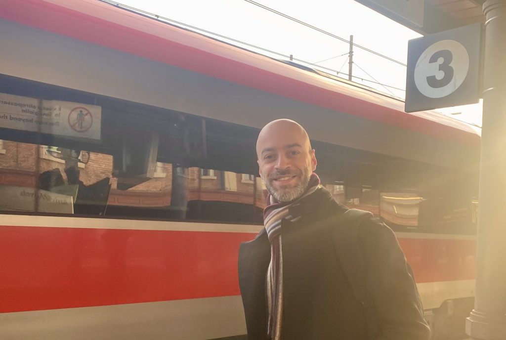 CEO Giacomo Mantovani in front of an high speed train at the station.