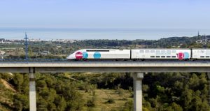 Ouigo train passing on a bridge.