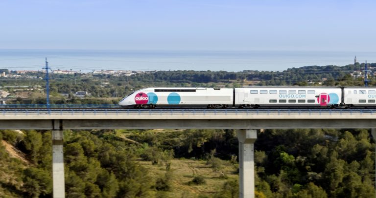 Ouigo train passing on a bridge.