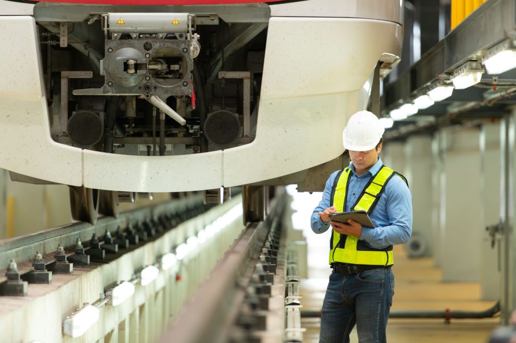 A train operator checking a tablet