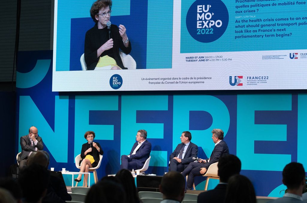 People talking to a panel during EUMO exhibition.